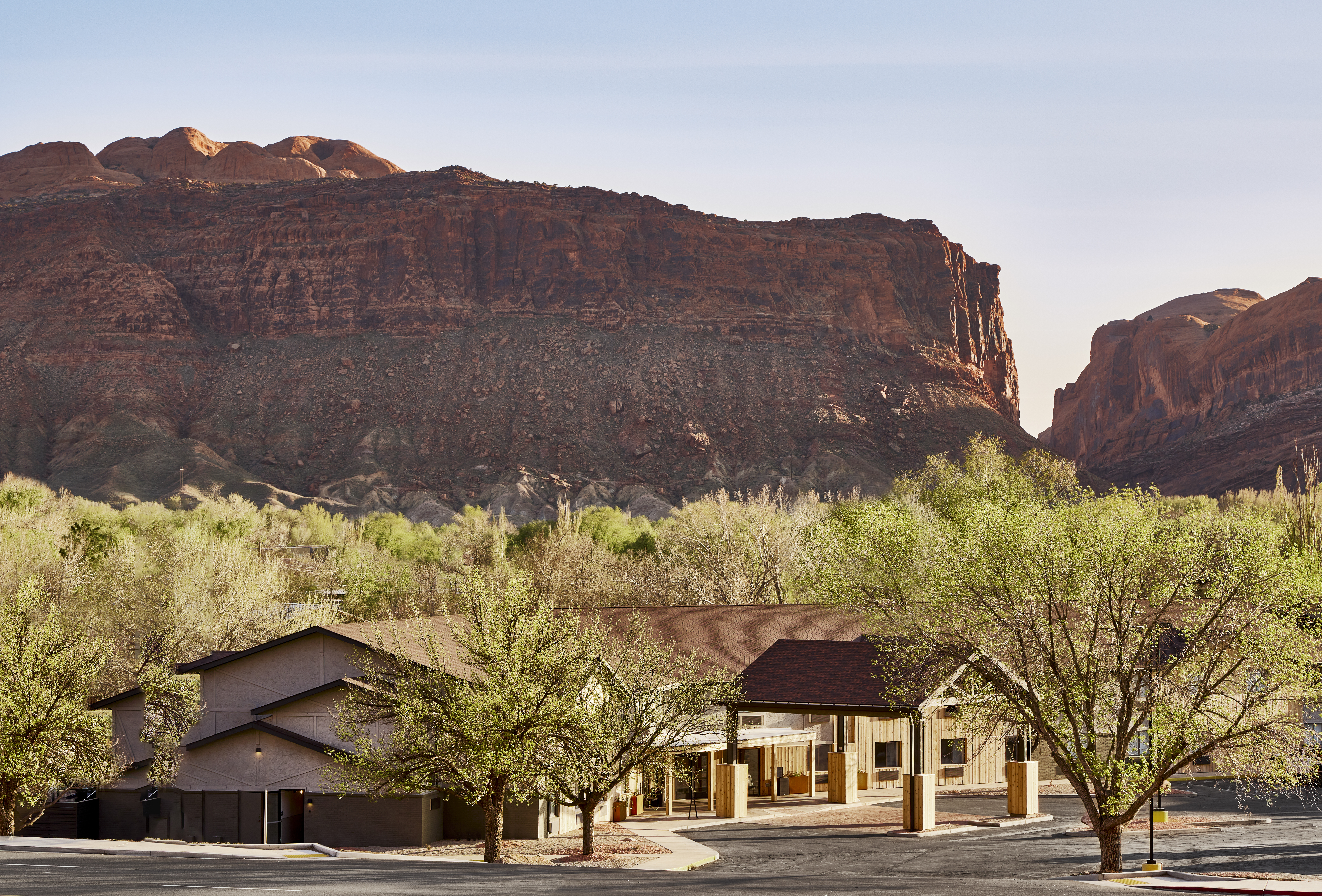 Slackline Moab, Outset Collection by Hilton - Exterior of hotel with mountains in the background, surrounded by trees