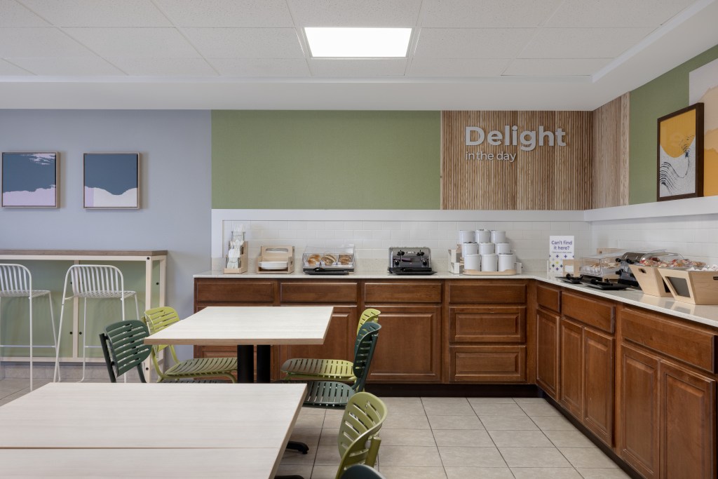 The breakfast bar with various food, and tables and chairs