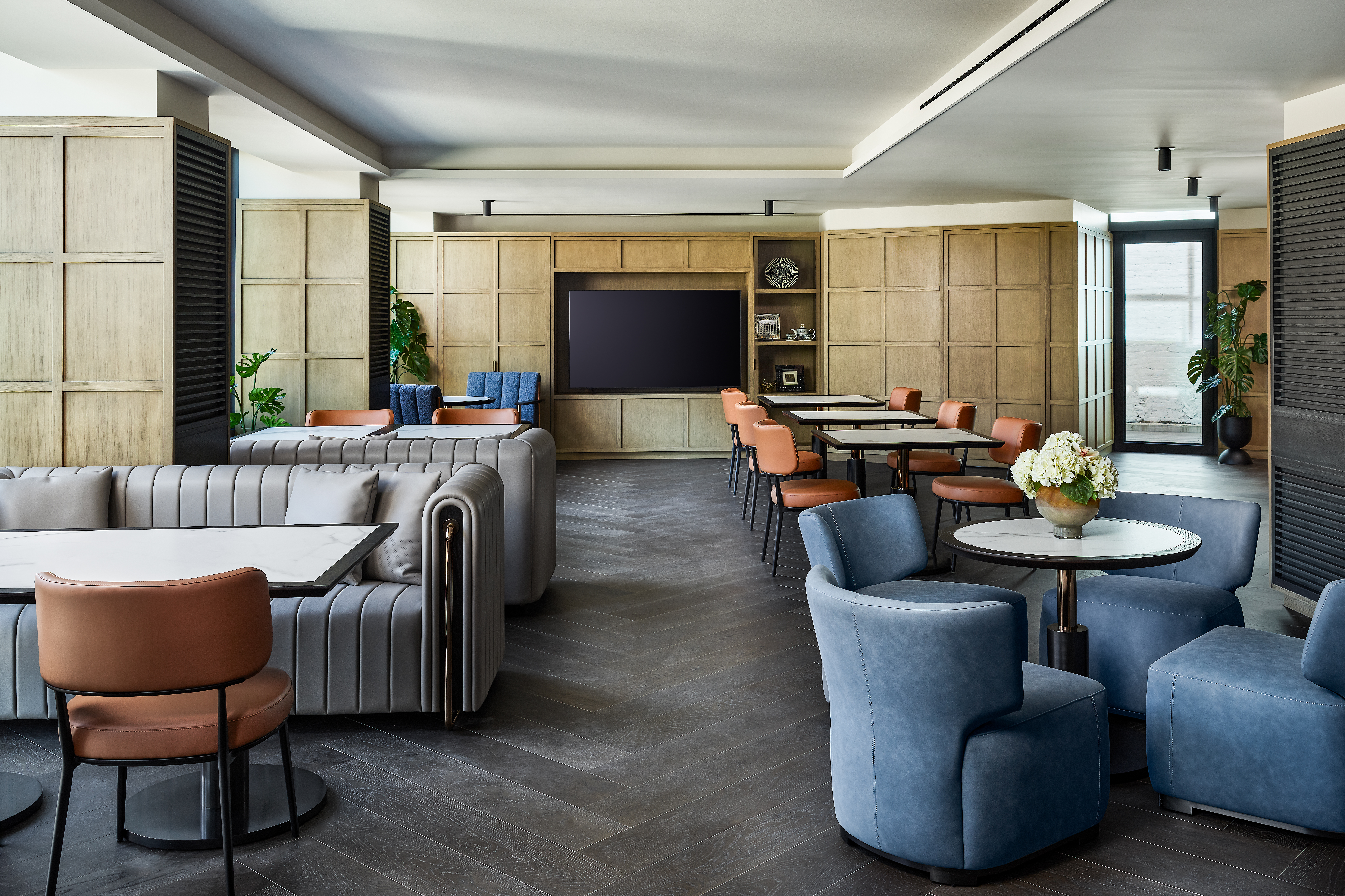 A dining room with various seating options including booth seats and small tables.