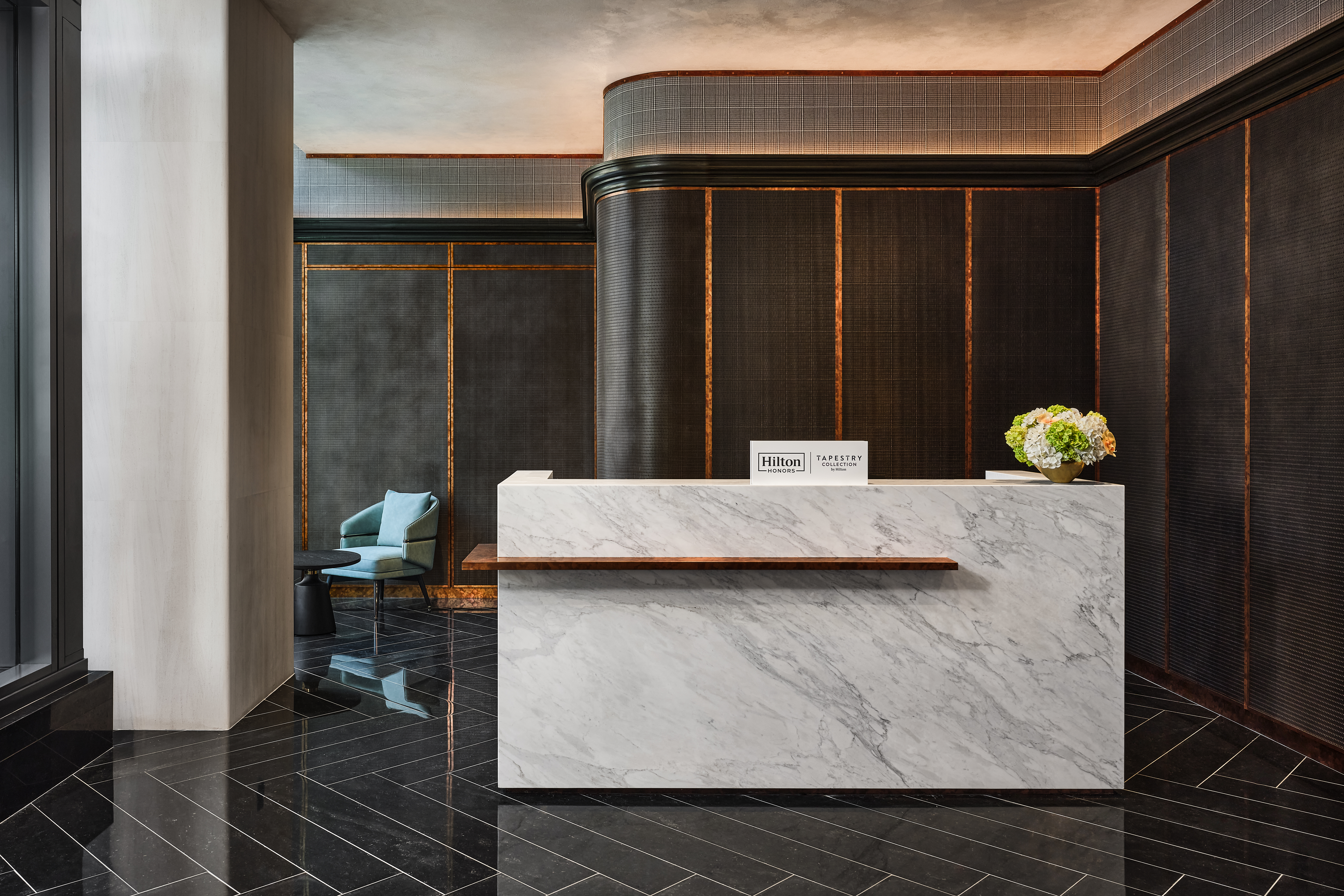 A marble desk in front of a dark textured wall