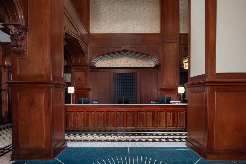 The front desk in the lobby framed by pillars