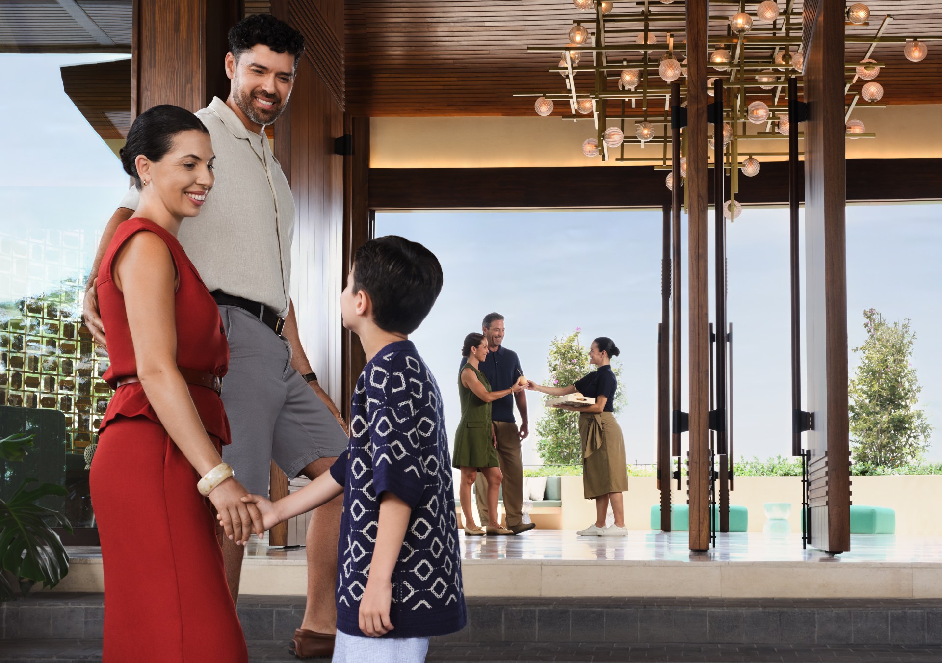 Waldorf Astoria Costa Rica Punta Cacique, family arriving at hotel, concierge greeting another family it the background