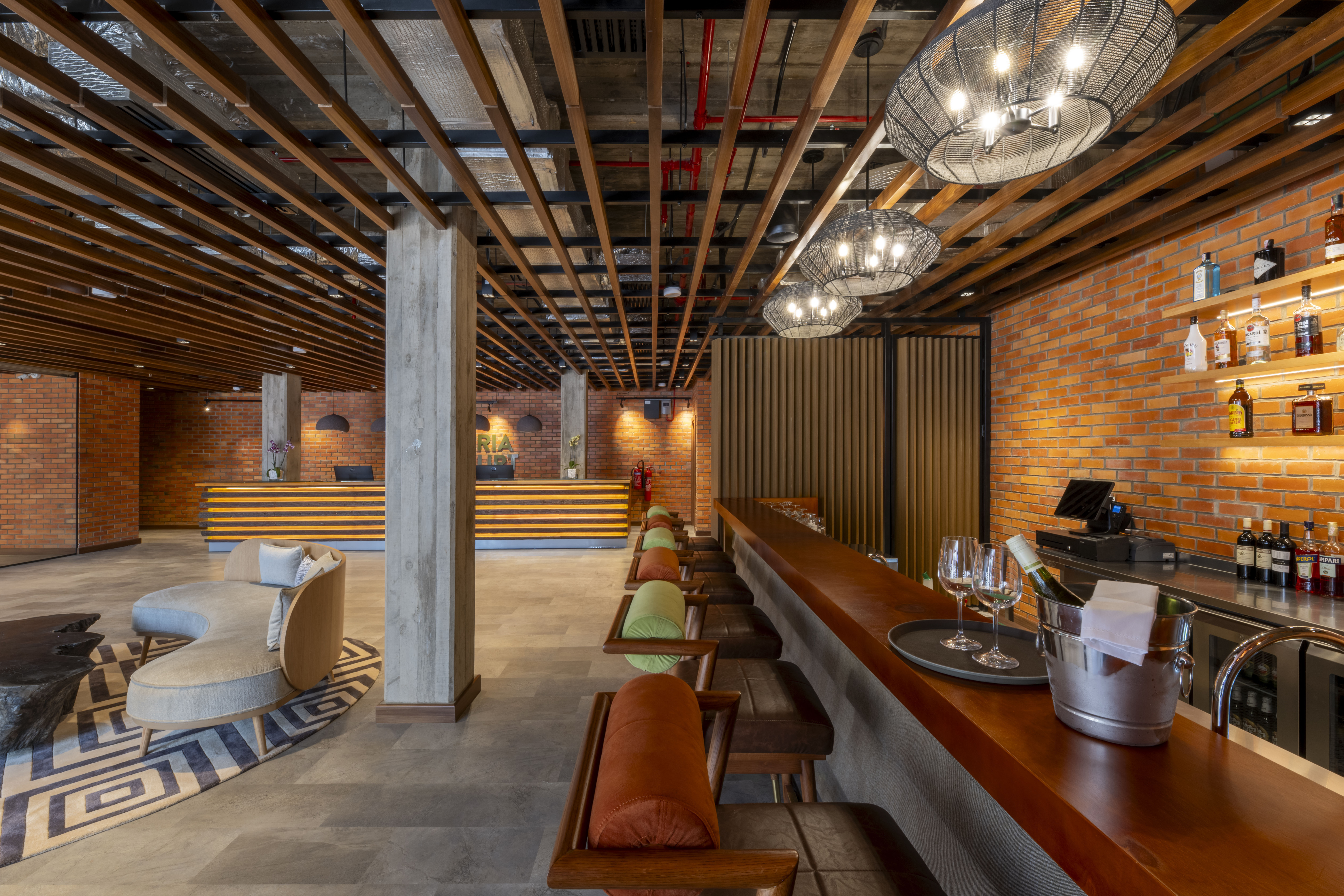 The lobby of the hotel with front desk, bar, and seating area