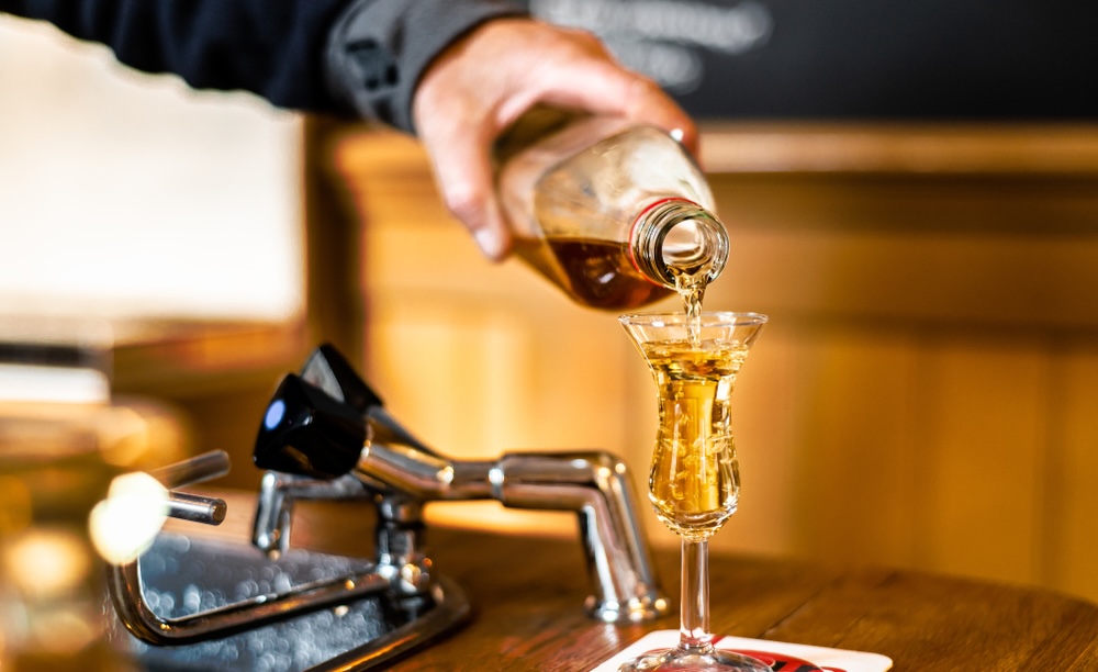 Dutch Bartender in Amsterdam Pours Jenever - Photo Credit: Photography by Adri/Shutterstock