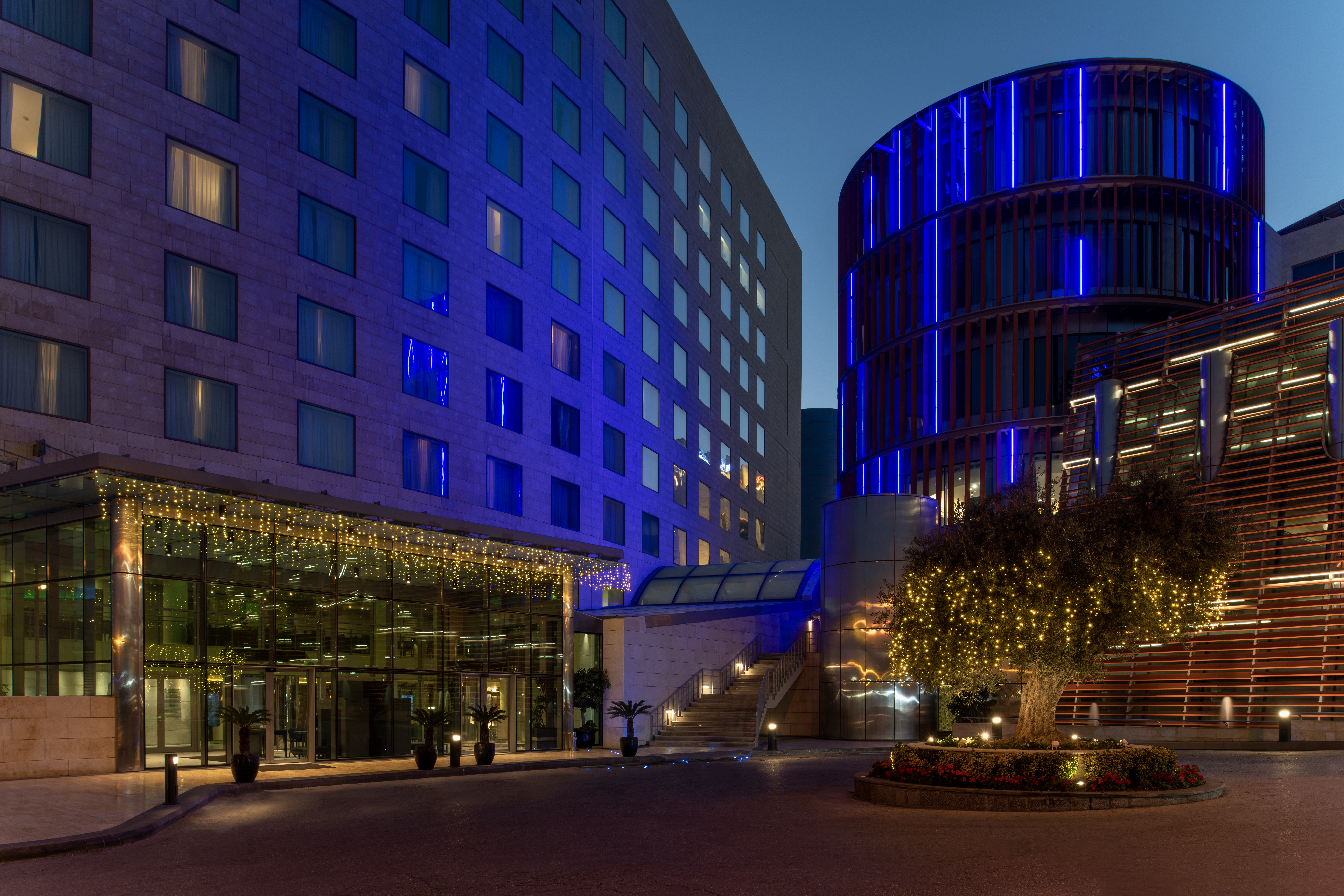 The exterior of the hotel lit up at night