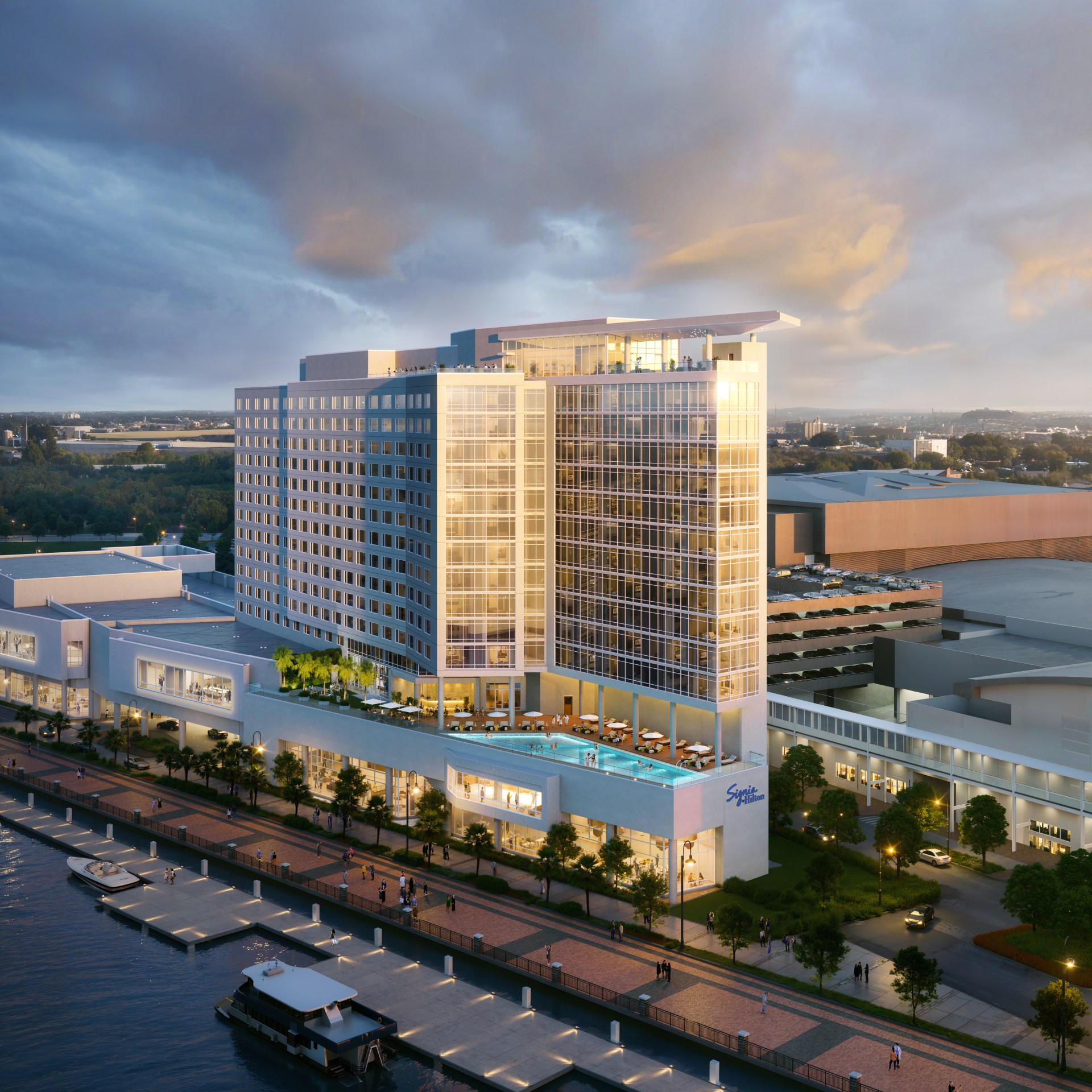The exterior of the hotel with the water and boardwalk running in front