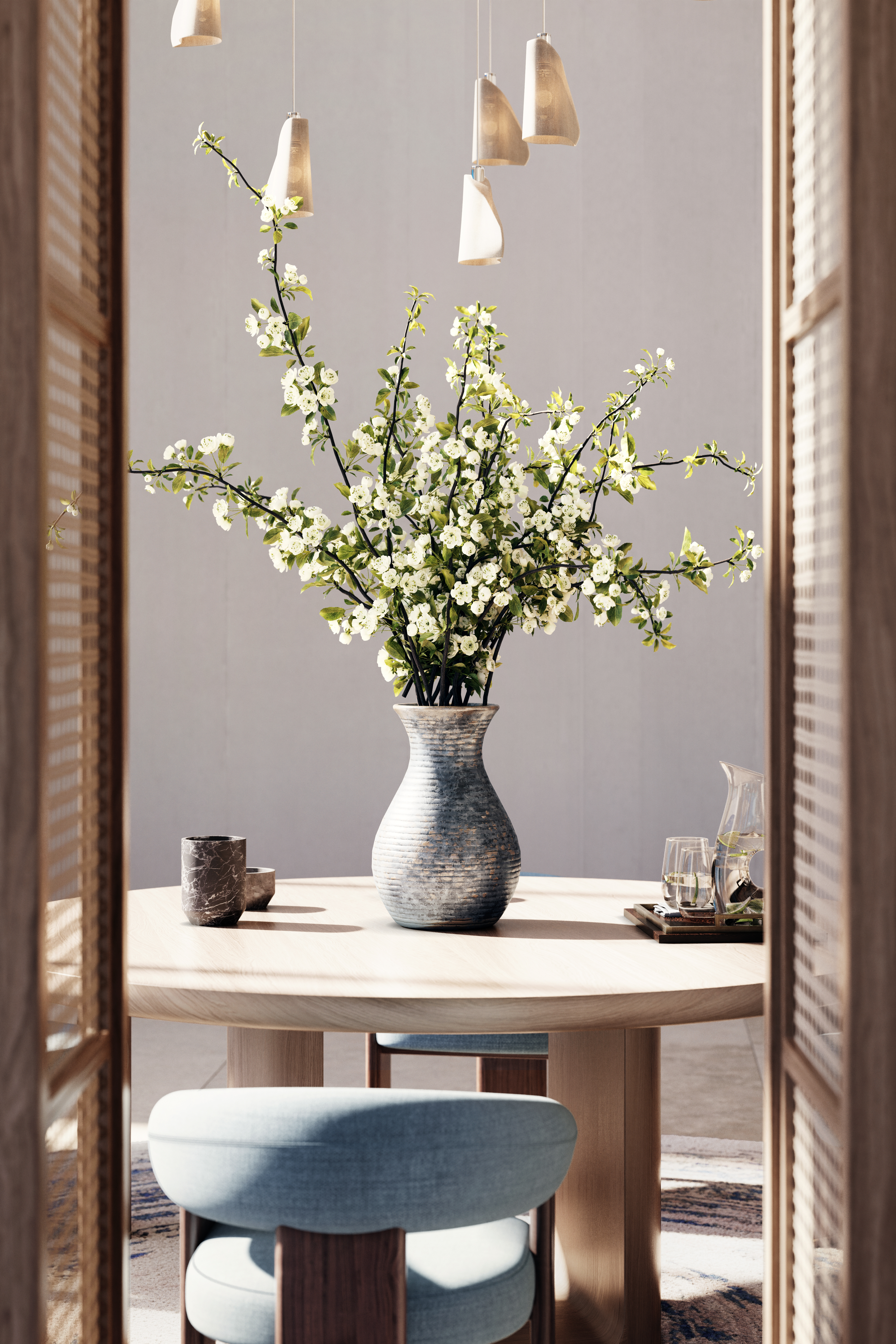 A vase of flowers on a table with chairs around