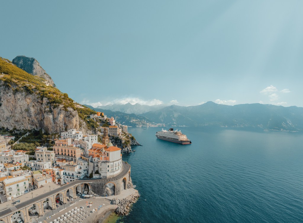 Aerial view of the stunning Amalfi coast with road and the Atrani town with arched road in Italy and Explora Journeys - EXPLORA II