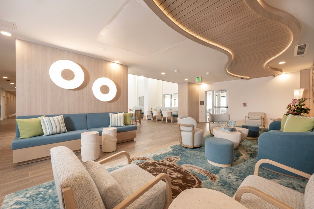 Hampton by Hilton St. Thomas - lobby with a variety of blue and cream seating areas, wavy wood feature on ceiling