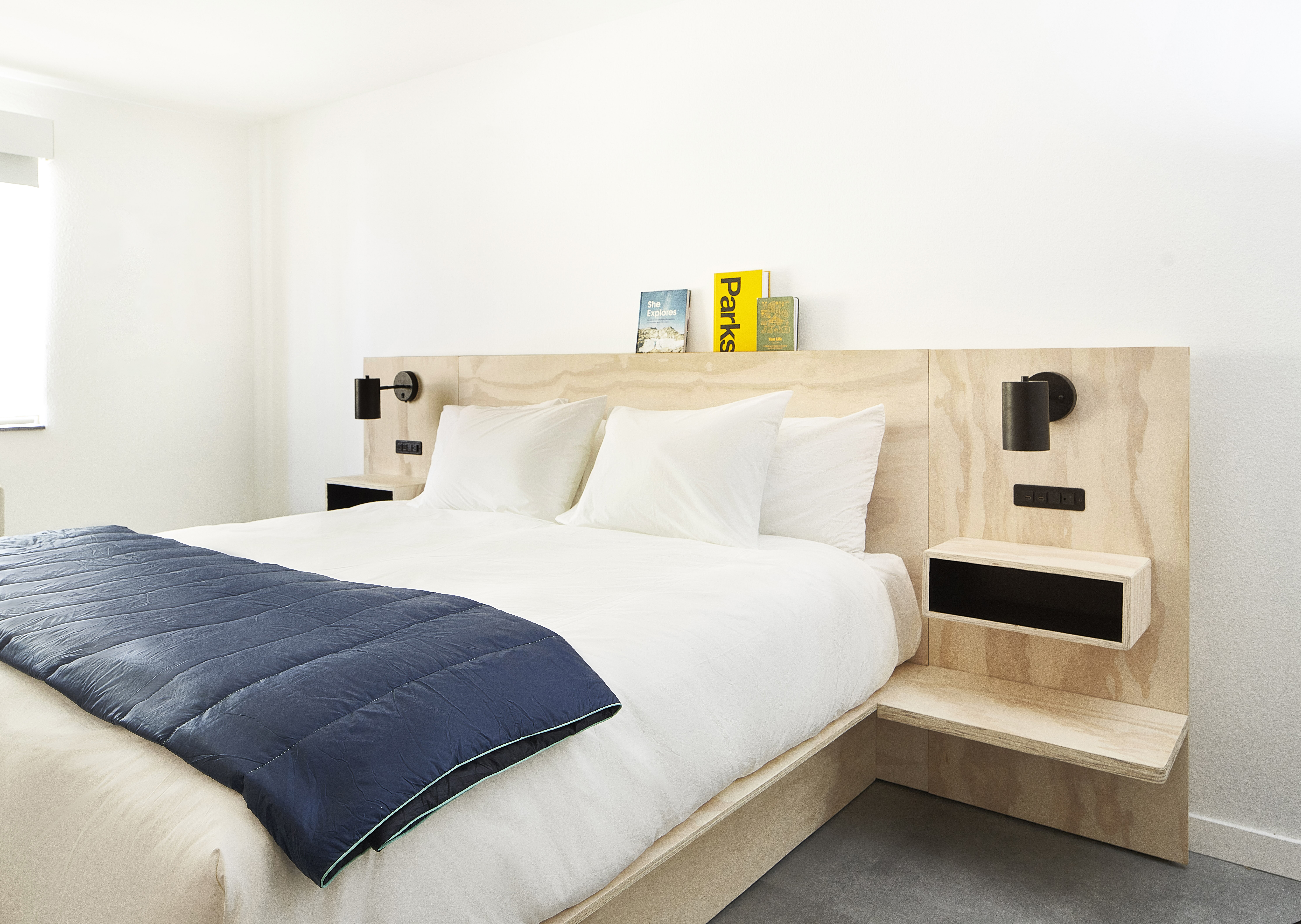 A bed with built in nightstands.