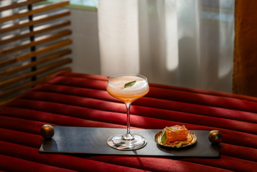 A cocktail drink on a tray