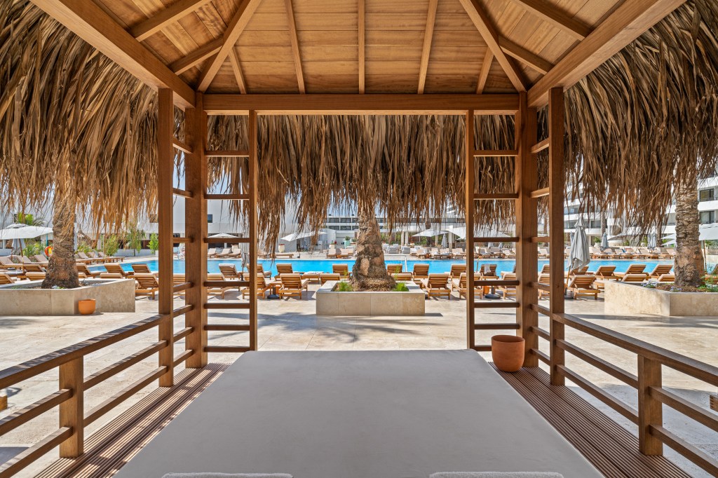 The inside of a cabana looking out at the pool