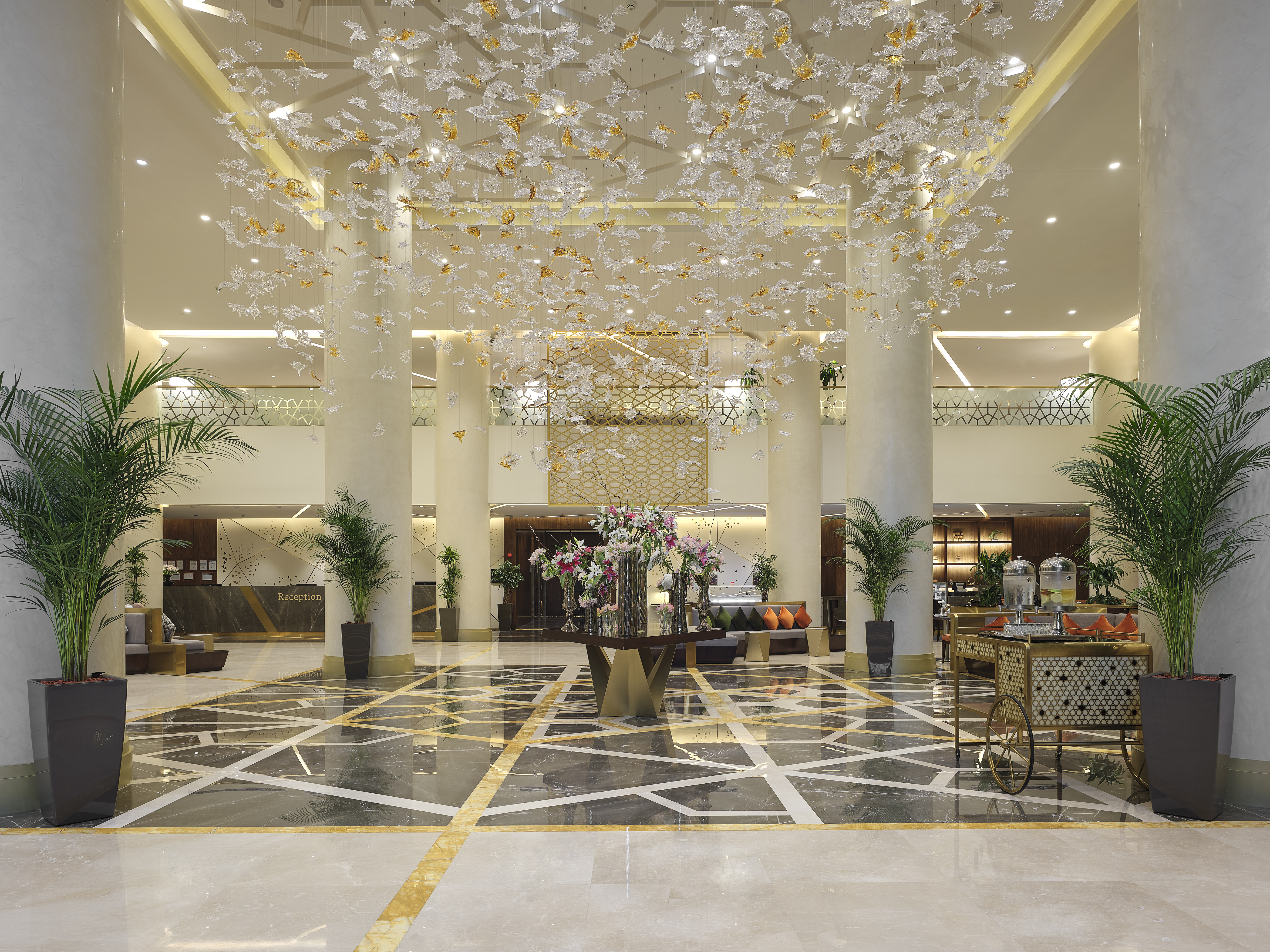 DoubleTree by Hilton Makkah Aziziyah Lobby with potted green plants and a floral arrangement