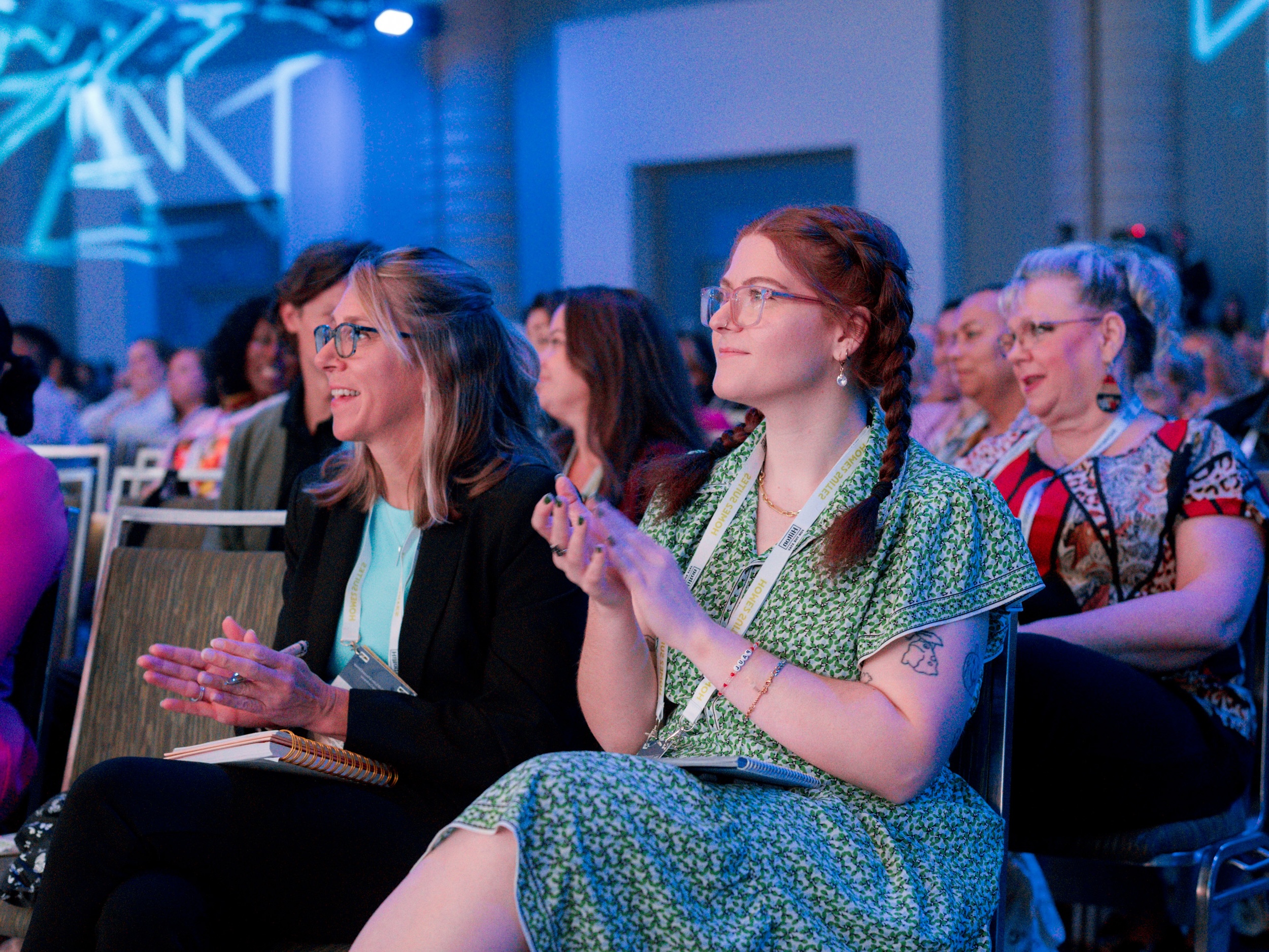 audience members at a conference looking at the stage