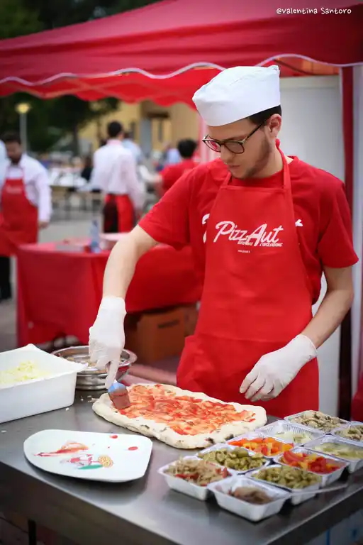 man making a pizza with PizzAut