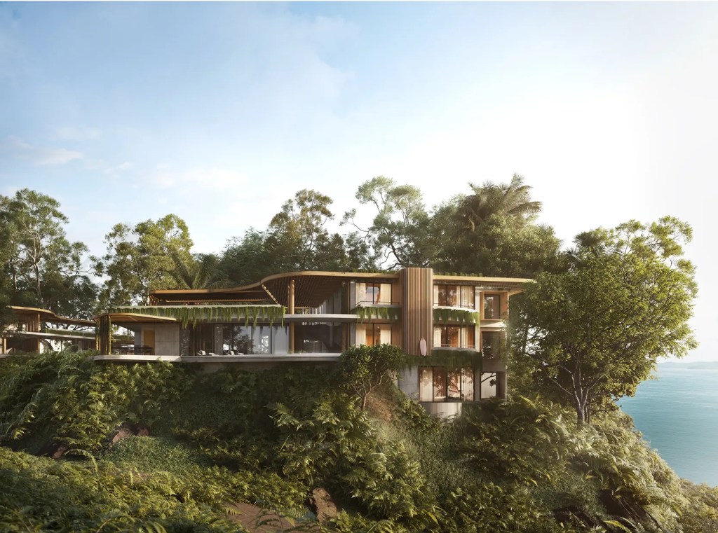 Modern hillside home with glass walls, wood accents, and integrated greenery overlooking the ocean.