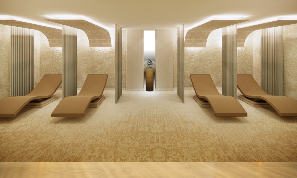 Sala de spa minimalista con cuatro sillones color canela, paredes beige texturizadas e iluminación ambiental suave en Signia Restore.