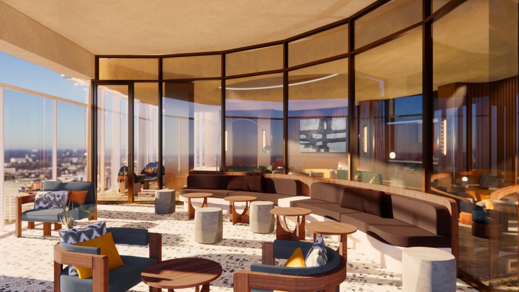 Modern lounge area at the Signia Hilton Indianapolis with curved brown sofa, wooden chairs with cushions, round tables, and large floor-to-ceiling windows overlooking a cityscape.