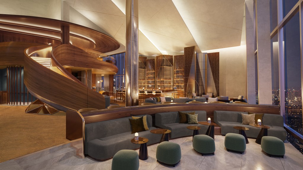 Luxurious modern lounge at the Signia Hilton Indianapolis with curved wooden staircase, gray sofas, green ottomans, and large windows overlooking a cityscape at night.